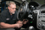 Gary Pittam performs recall service on a Chevrolet Cobalt Thursday, April 17, 2014