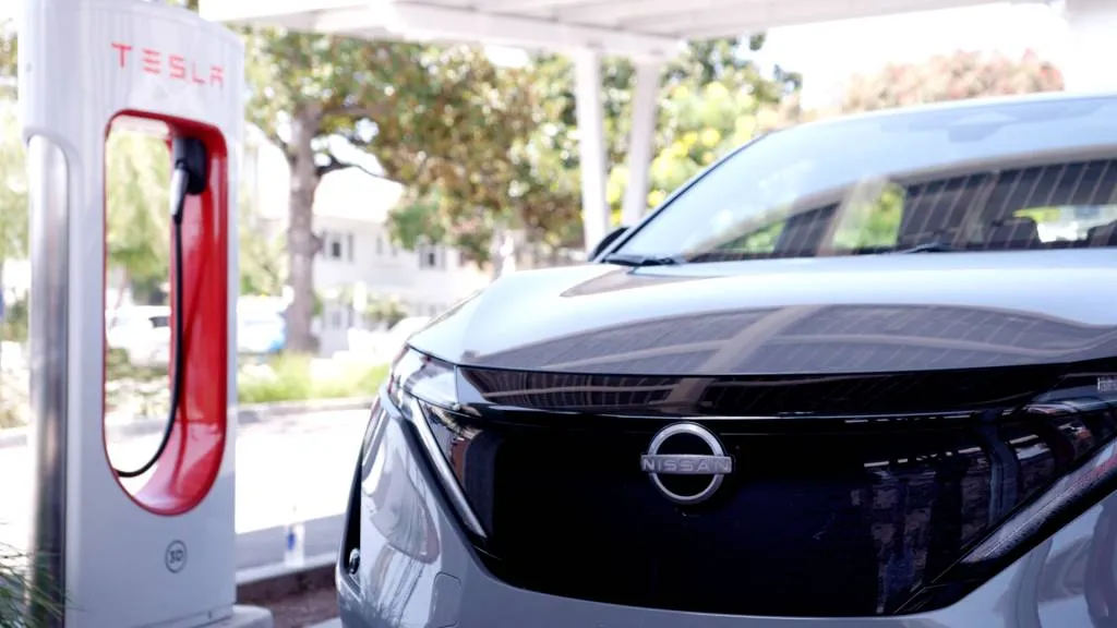 Nissan Ariya at Tesla Supercharger station